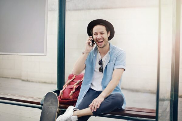 man in white button up shirt sitting on brown wooden bench