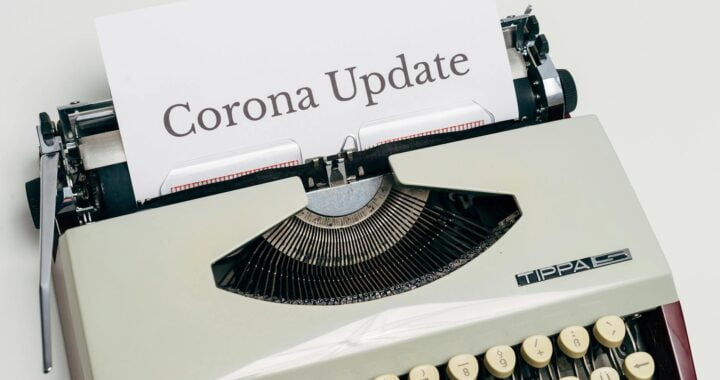 a vintage typewriter with corona update typed on white paper