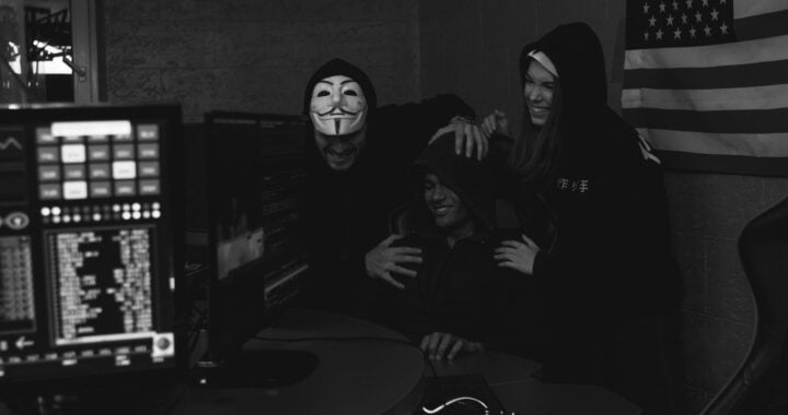 monochrome photo of people hacking a computer system