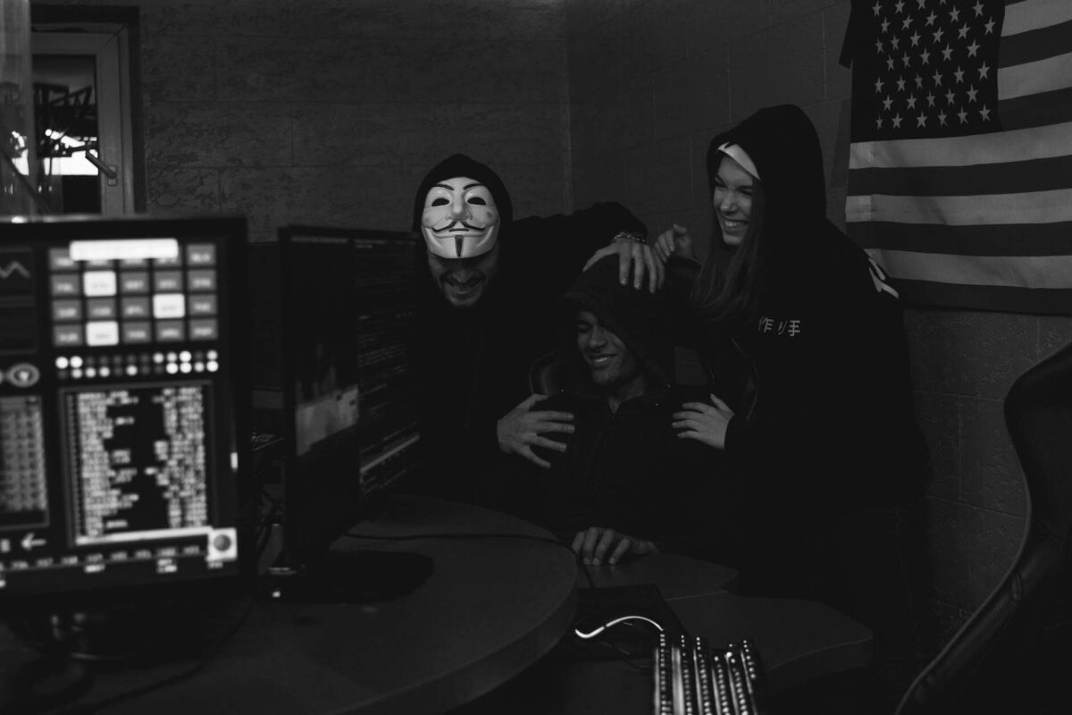 monochrome photo of people hacking a computer system